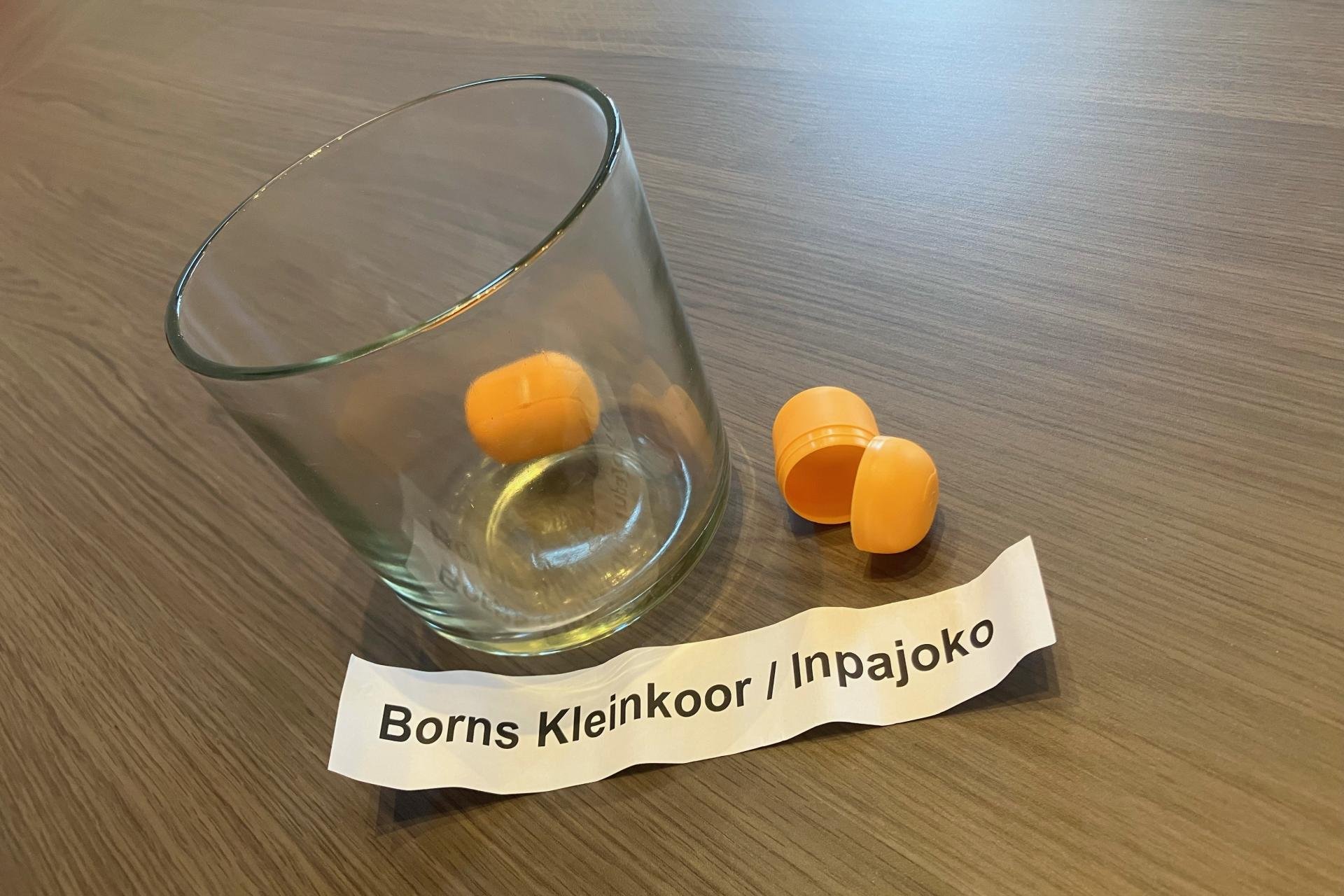 Glazen pot met lotingballen erin met papiertje 'Borns Kleinkoor / Inpajoke.